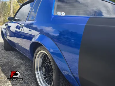A professional using a dual-action polisher to perform a paint correction.